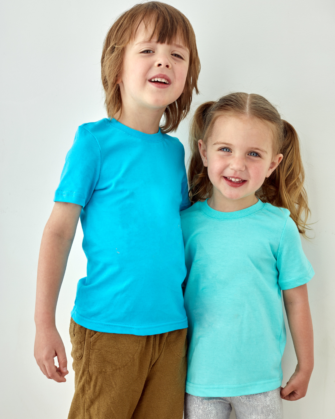 Two siblings laughing together.